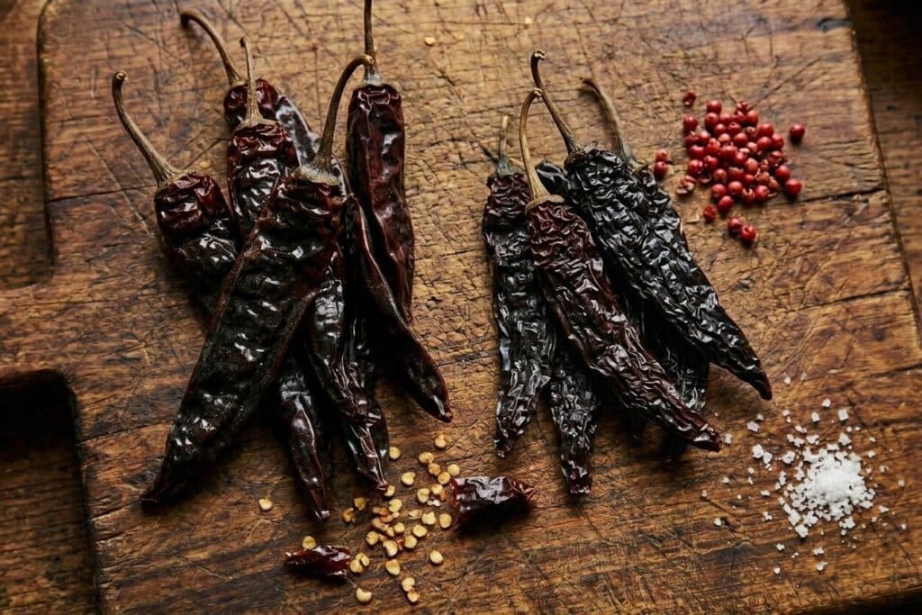 Pasilla Oaxaca and Pasilla Negro (regular pasilla) on a cutting board